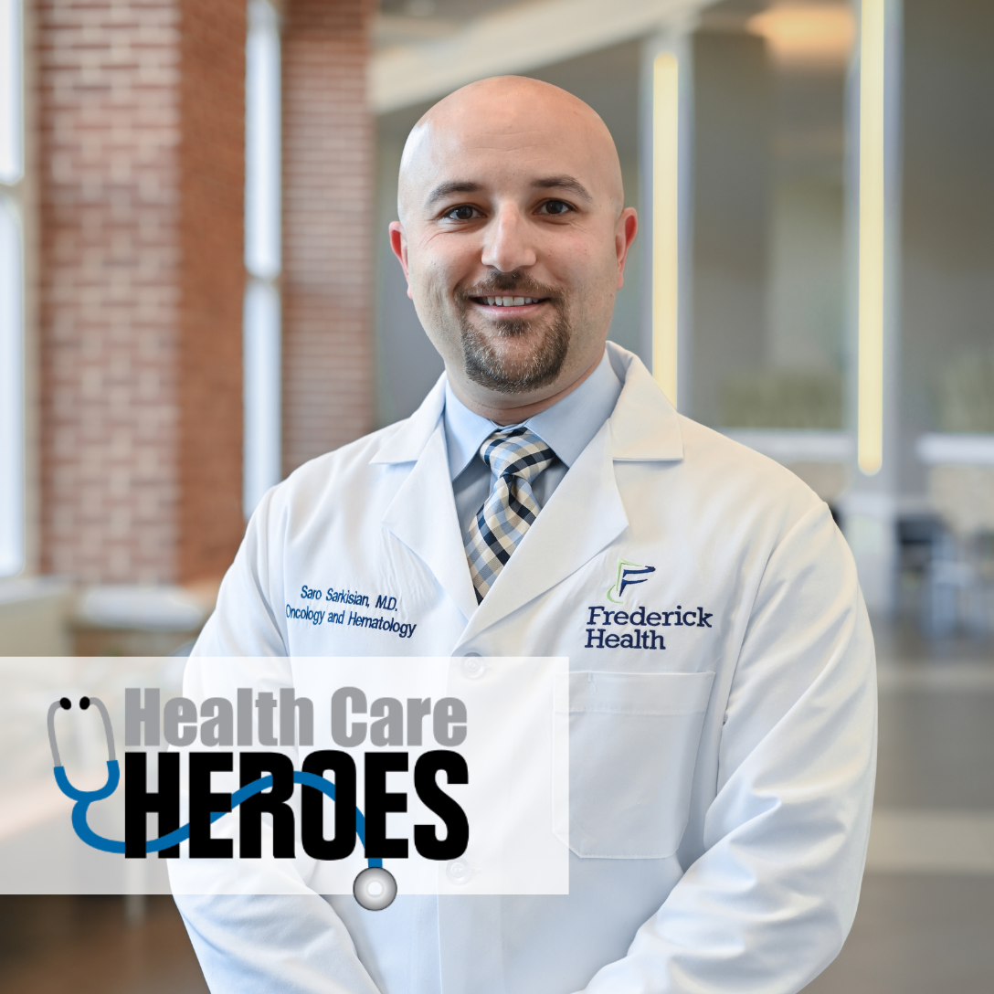 Smiling doctor in lab coat with "Healthcare Heroes" emblem on image
