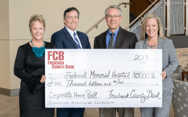 group holding a check