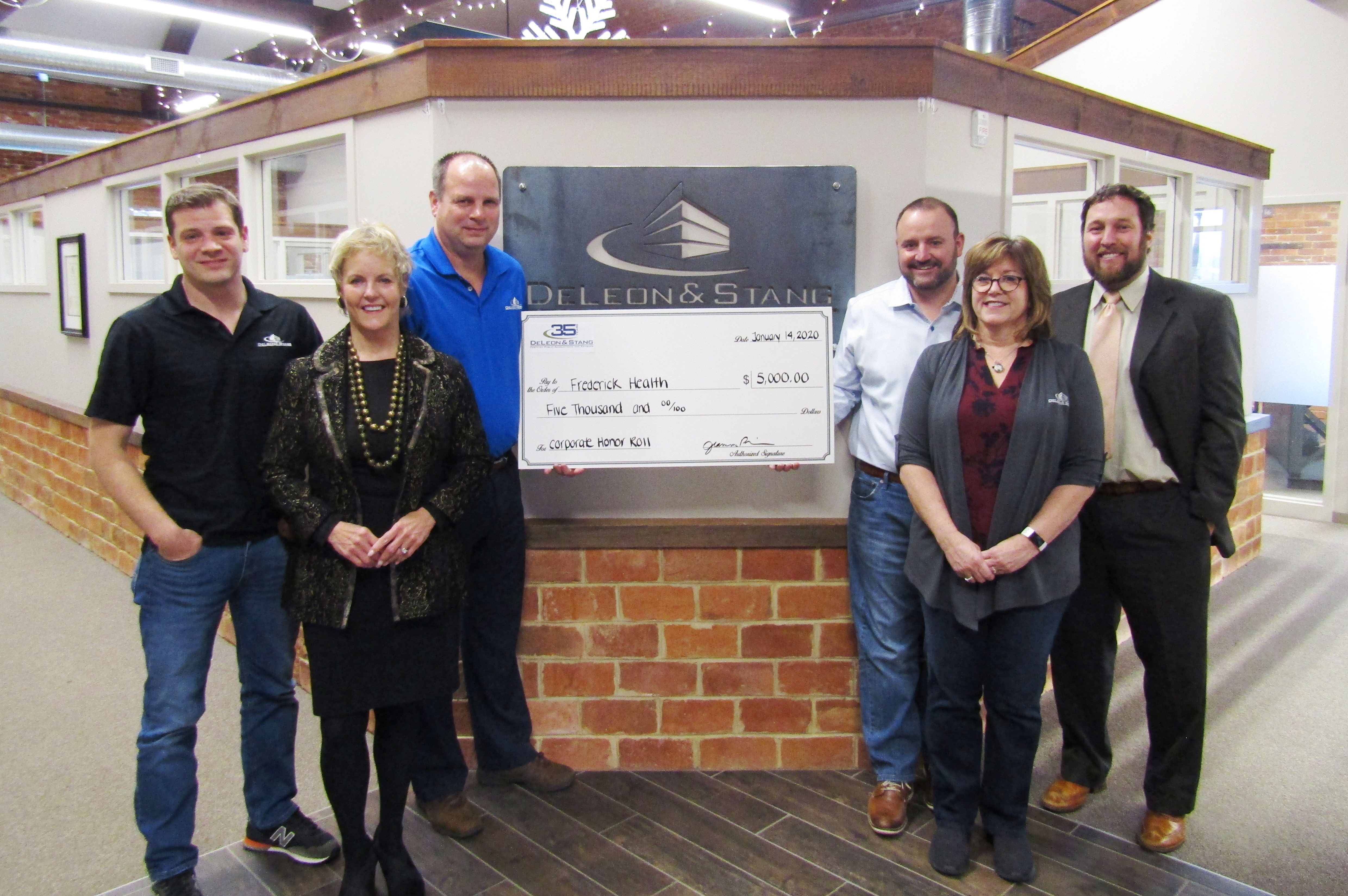 group of people with large check